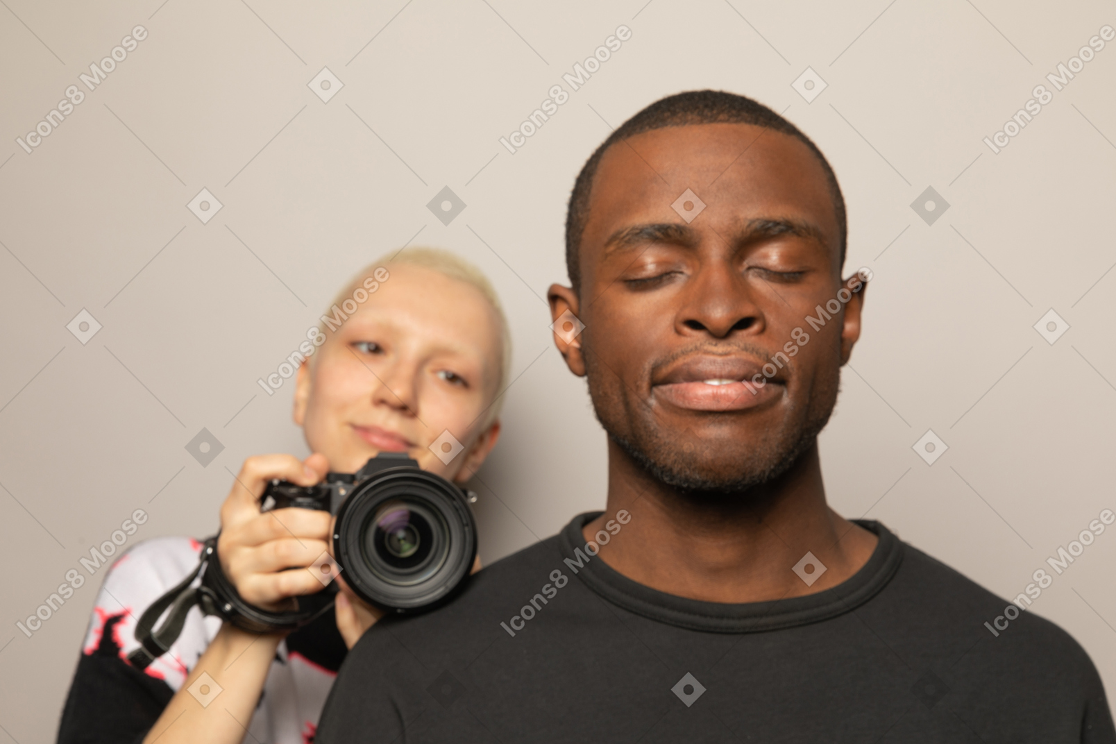 Smiling woman with camera looking at man