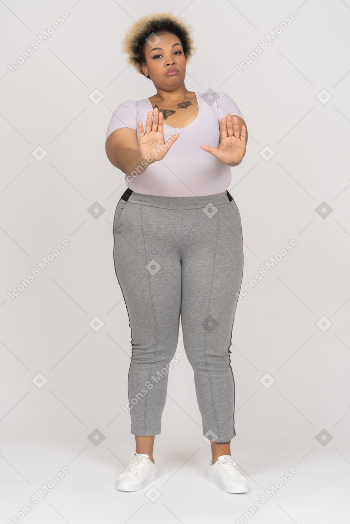 Black woman making a stop hand gesture with both arms