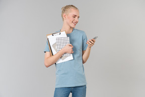 Cute young androgynous guy in a light blue t-shirt and blue jeans, on his way to college