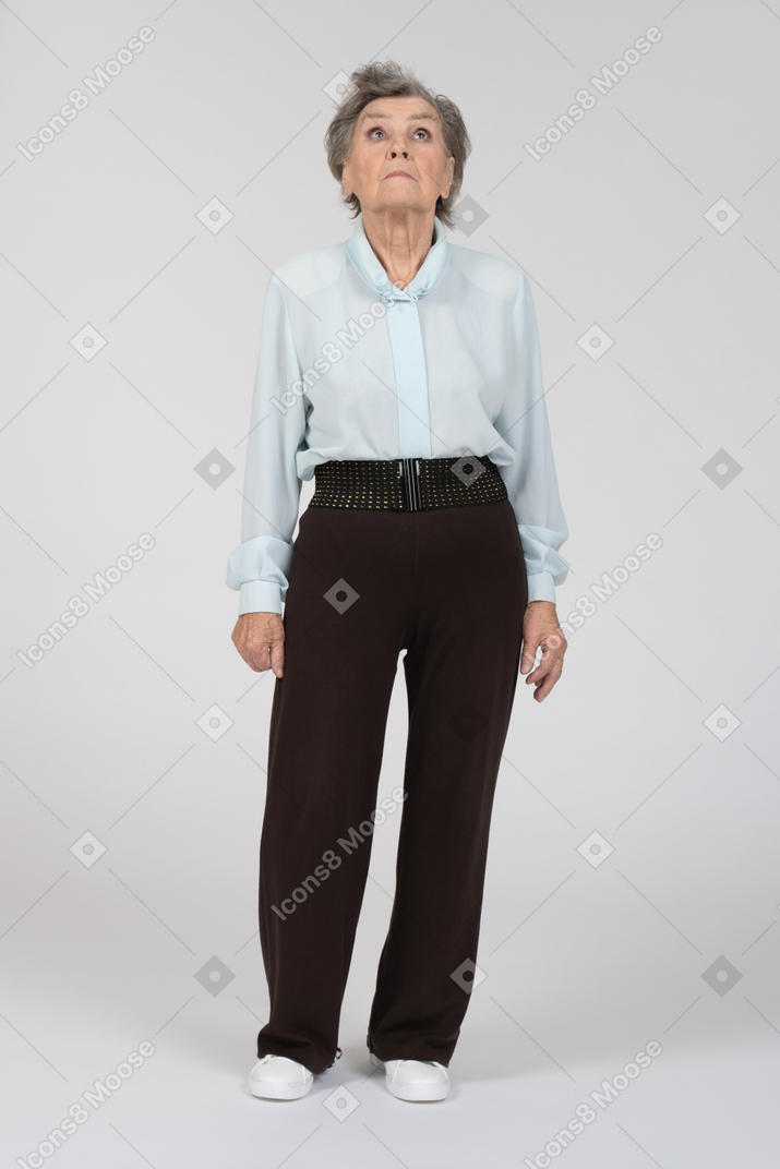 Front view of an old woman looking up cautiously