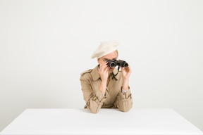 Fashionable woman looking through binocular