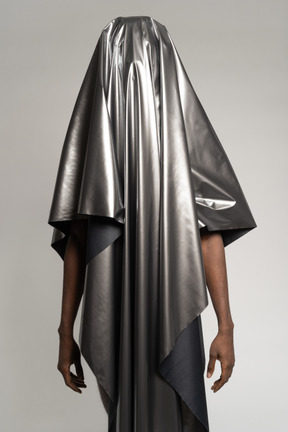 Man standing covered with silver satin
