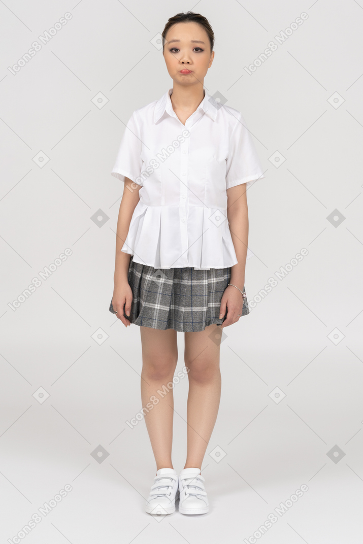 Una giovane donna asiatica in piedi con le braccia a lato