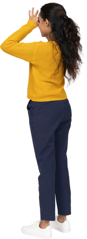 Side view of a girl in casual clothes looking through fingers