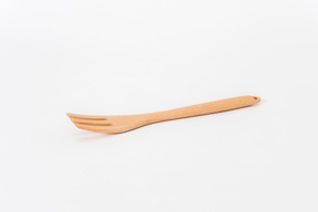 Wooden fork on white background shot from the side