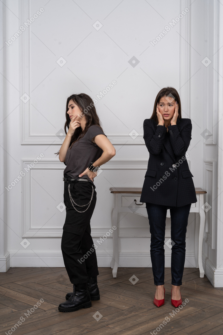 Thinking woman next to anxious woman