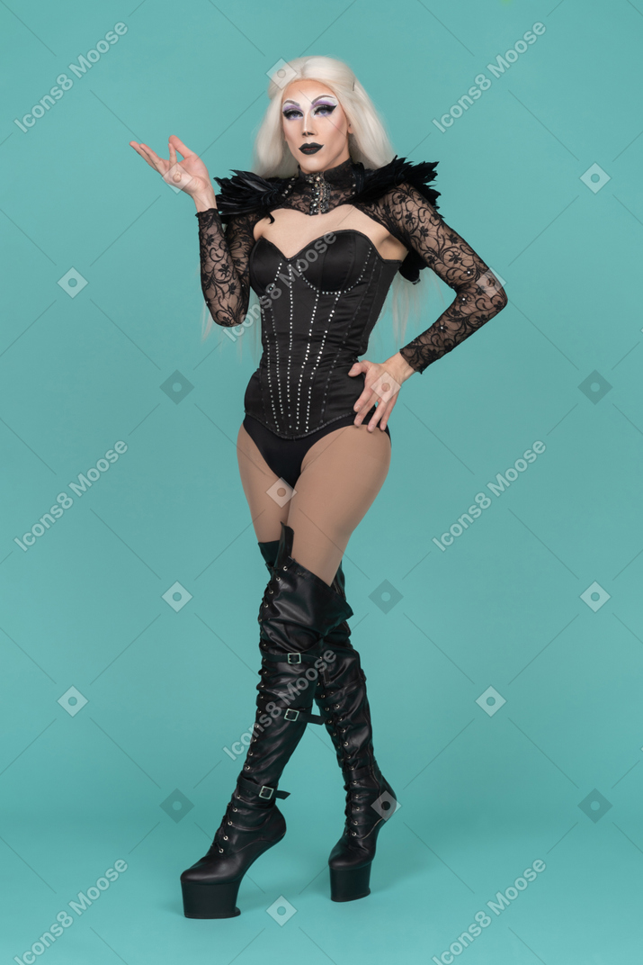 Transvestite with palm raised in question and hand on hip