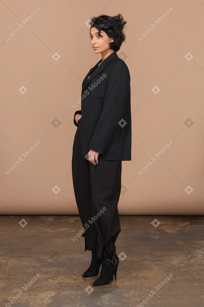 Three-quarter view of a  surprised businesswoman in a black suit
