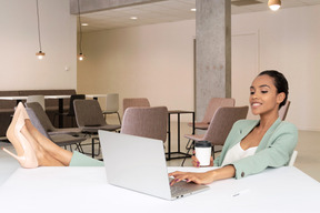 A woman sitting at a table with a laptop