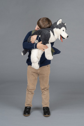 Portrait of a little boy hugging a plushie