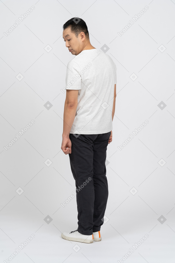 Man in casual clothes looking down