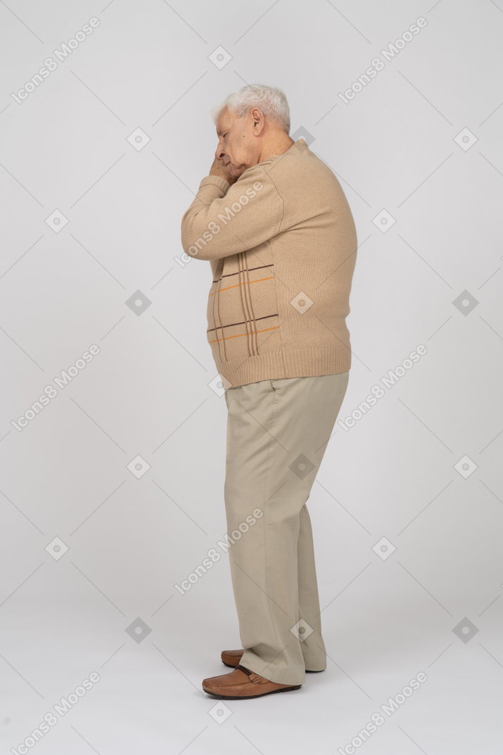 Side view of a sleepy old man in casual clothes