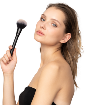 Side view of a sensual young woman holding a make-up brush & looking at camera