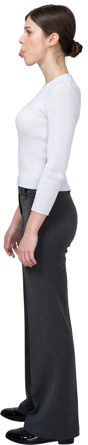 Side view of a young woman in office clothing wrapping tongue