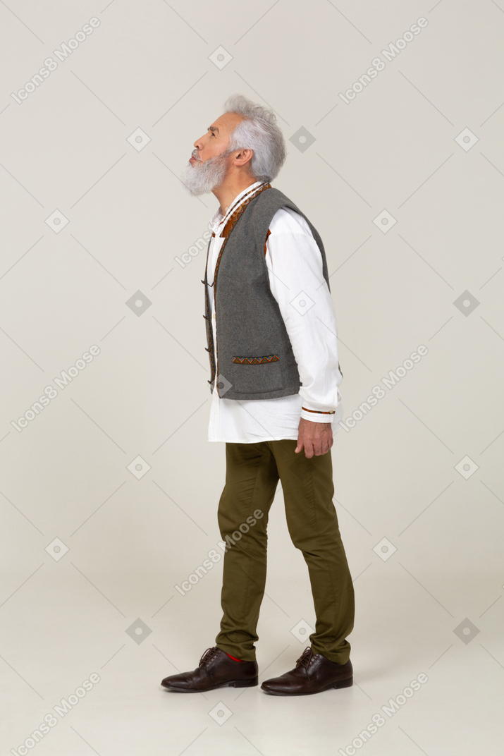 Side view of man squinting his eyes to get a better look at something