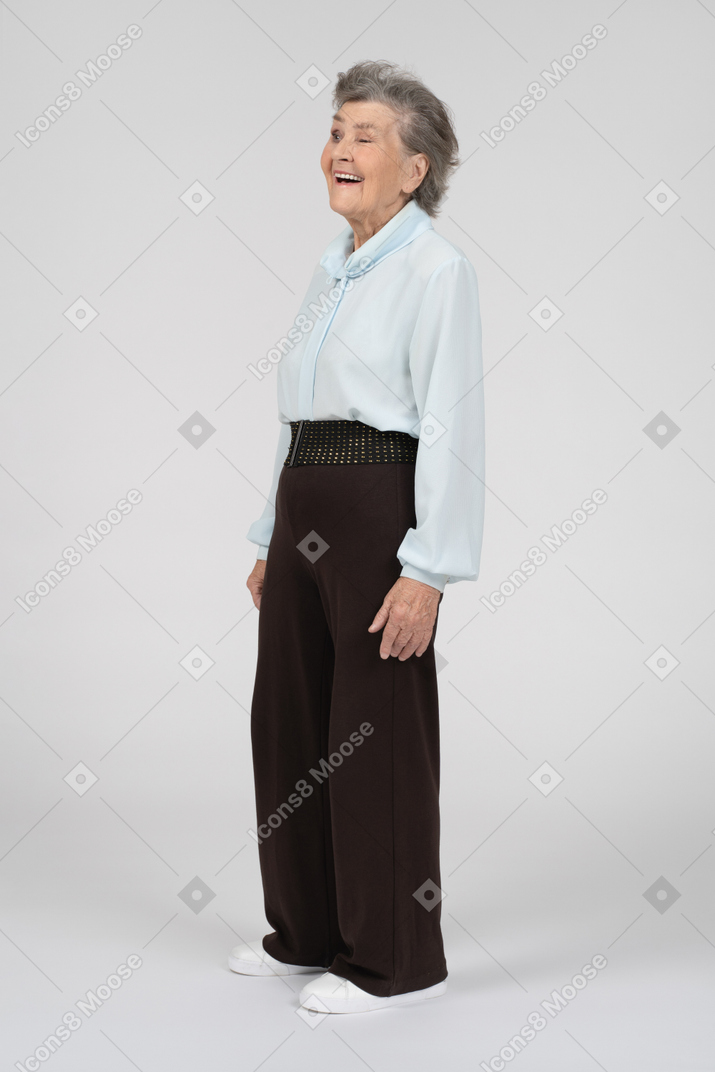 Vista di tre quarti di una donna anziana che sorride e fa l'occhiolino con l'occhio sinistro