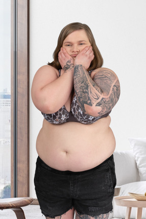 A woman with a large belly standing in a living room