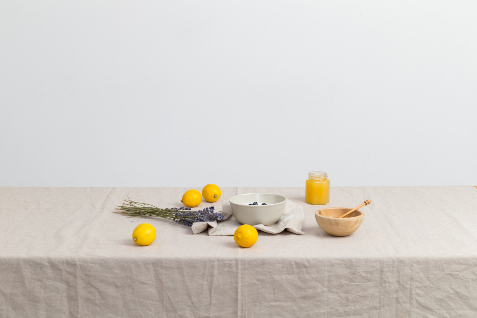 Lemons, jar of honey and dried flowers