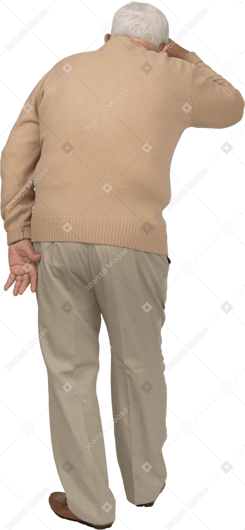 Rear view of an old man in casual clothes looking for something