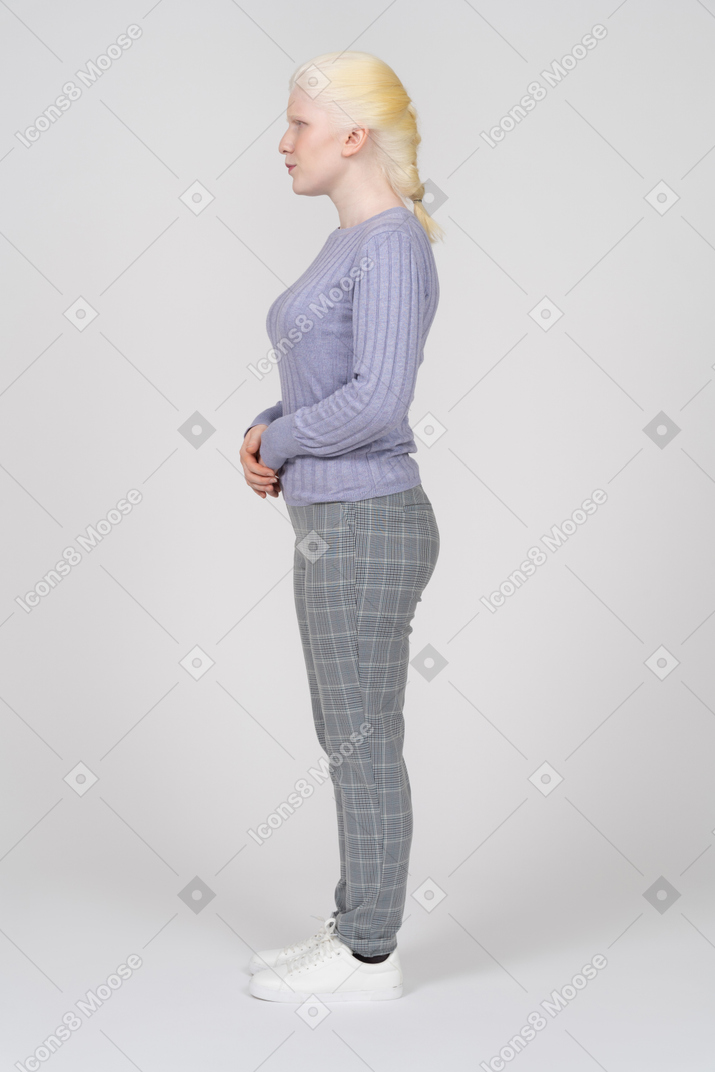 Side view of a blonde woman in casual clothes