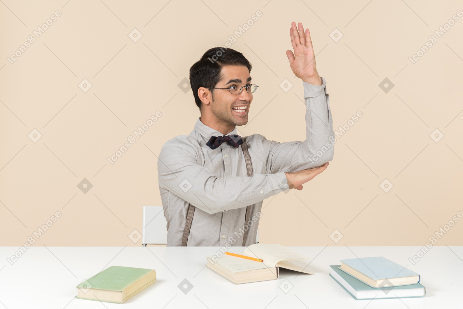 Adult student sitting at the table and raising a hand
