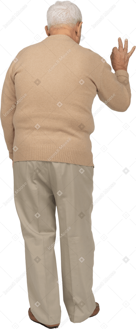 Rear view of an old man in casual clothes showing ok sign