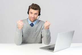 Call center agent doing fist pump while working