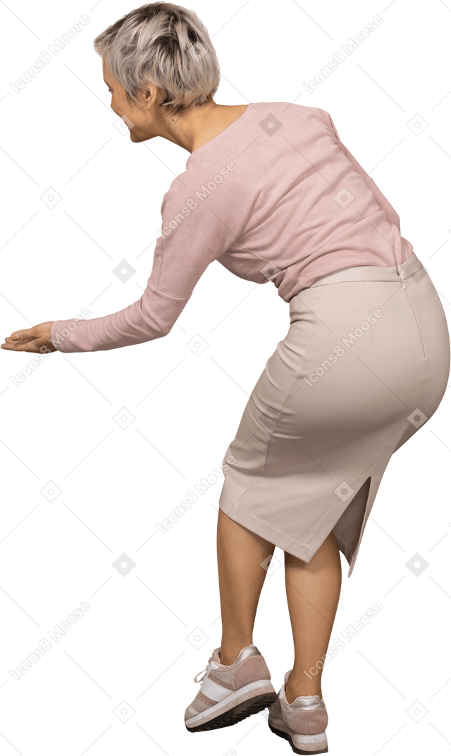 Rear view of a woman in casual clothes making a welcoming gesture