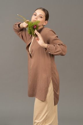 Young woman holds a bouquet near her face