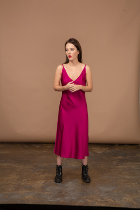 Front view of a beautiful young woman in red dress