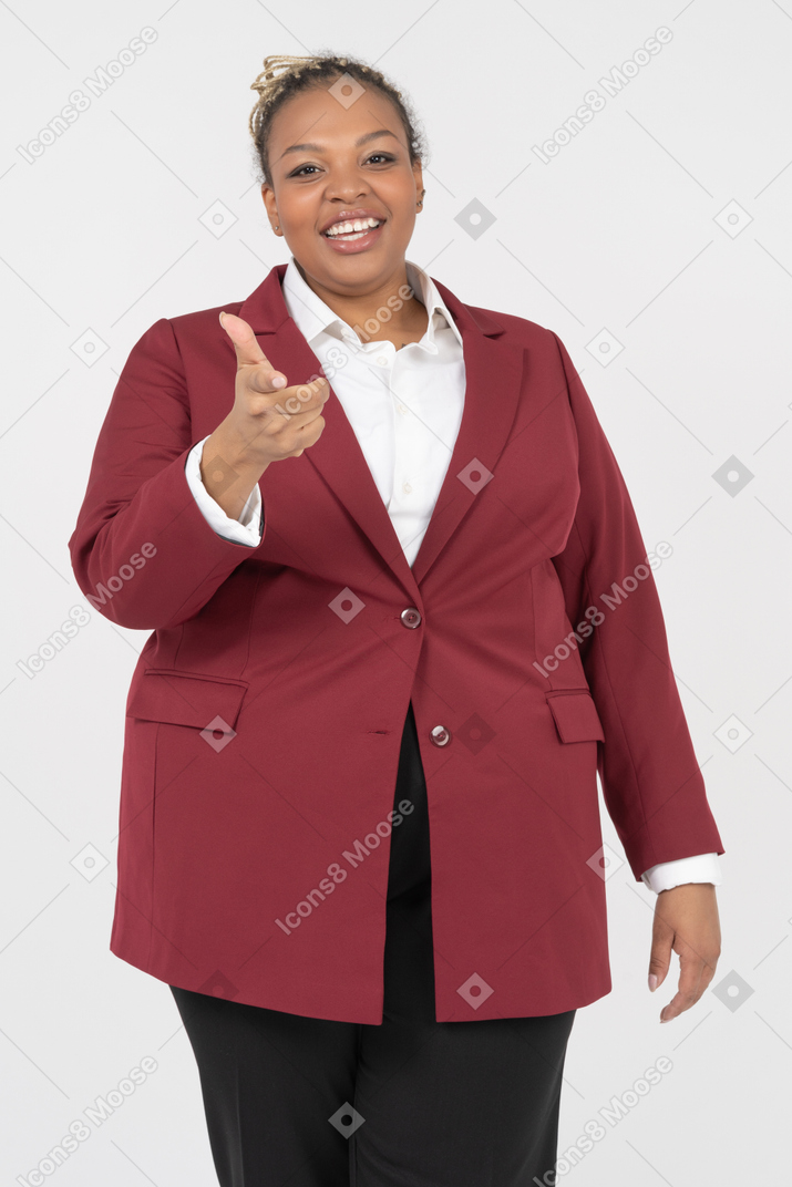 Happy office worker pointing with a hand