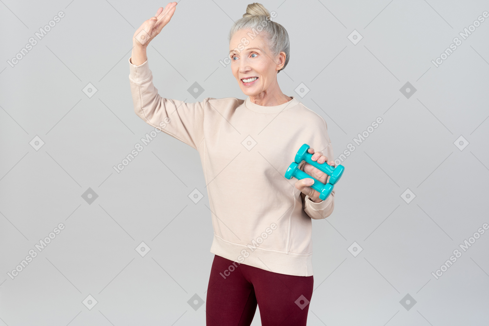 Smiling old woman holding hand weights in one hand