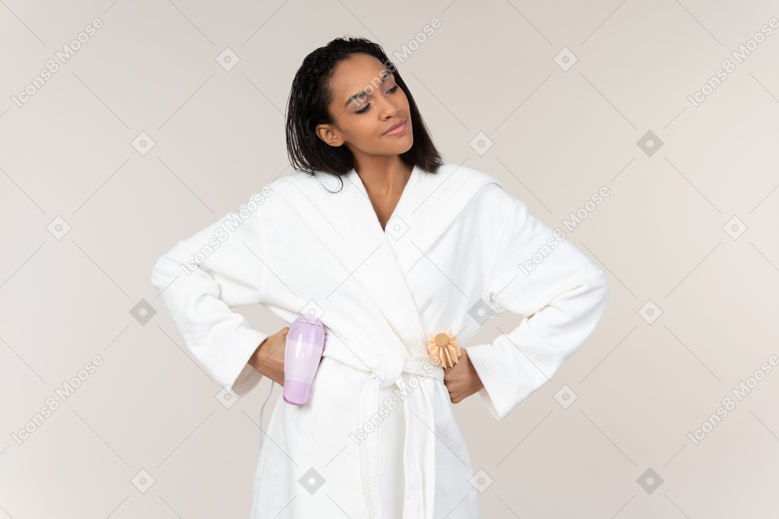 Positive afrowoman holding hair dryer and standing with hands on hips