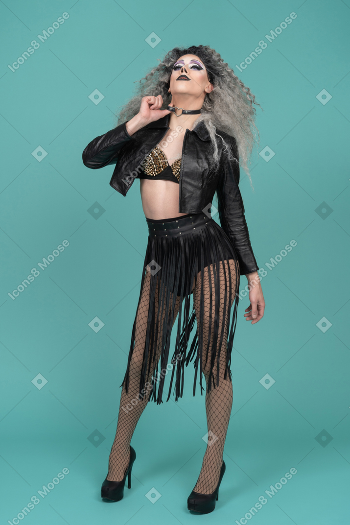 Drag queen in leather jacket tugging on choker