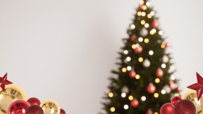 A christmas tree with red and gold ornaments