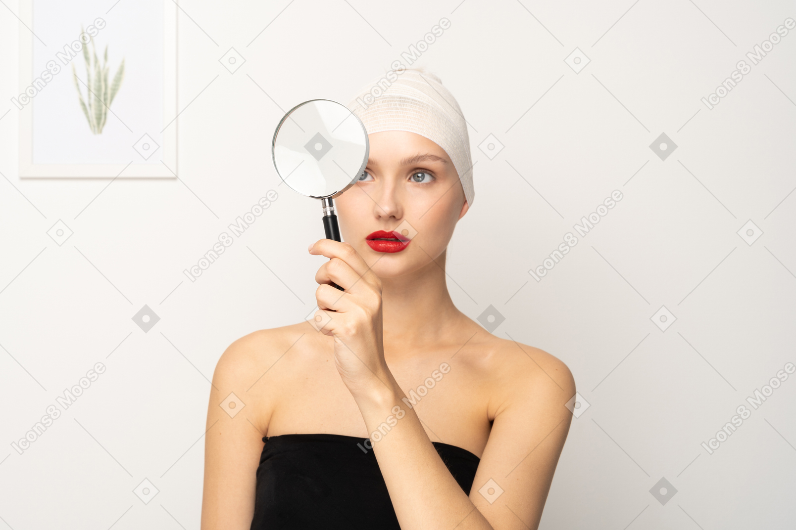 Young woman looking through magnifier