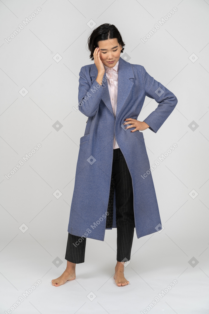 Woman in coat having a headache