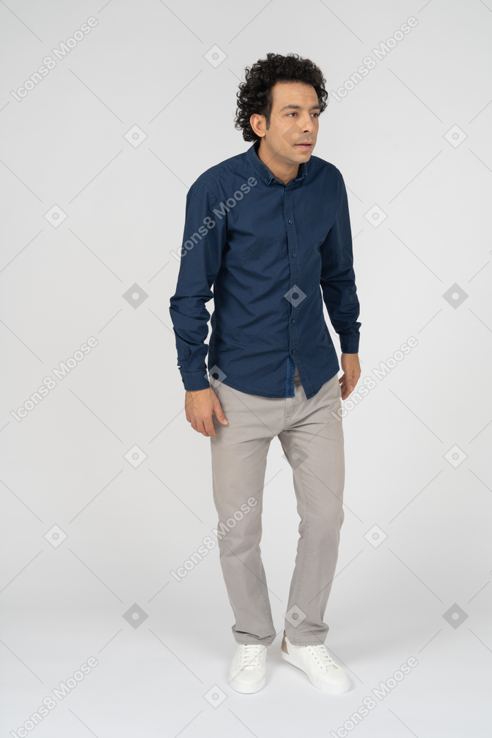 Front view of a man in casual clothes looking at something