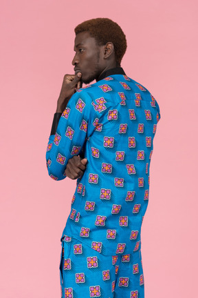 Black man in blue pajamas standing