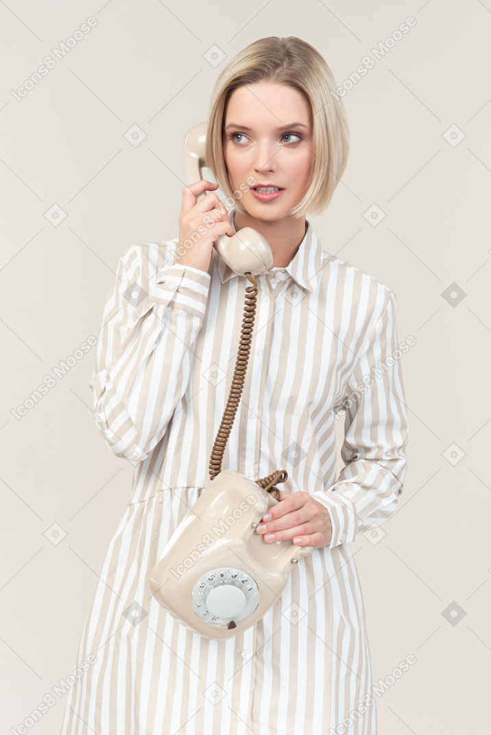 Young woman talking on the old rotary phone
