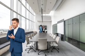 A man in a suit standing in a conference room