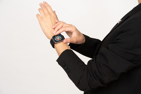 A cropped shot of a young woman wearing smartwatch