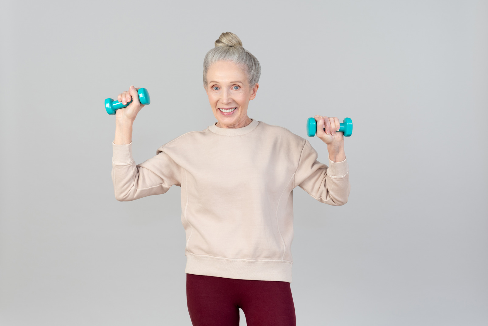 Old woman holding hand weights