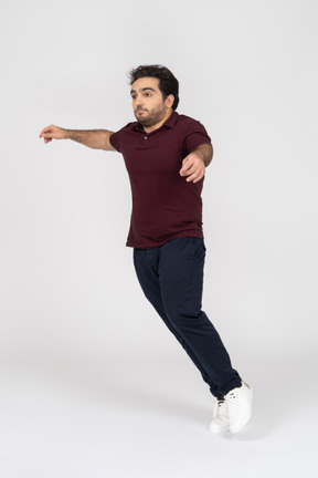 Man in casual clothes jumping to the side