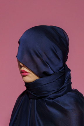 Close-up a young female wrapped in dark blue cloth