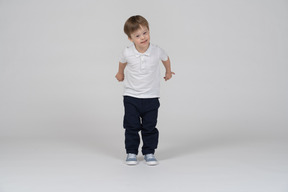 Front view of small boy swinging his arms