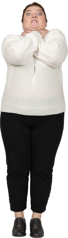 Vista frontal de uma mulher gorda em um suéter branco se chocando