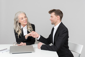 An older woman and a young man working together