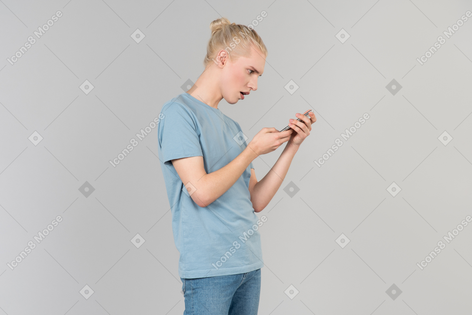 Shocked young guy standing in profile and looking aside