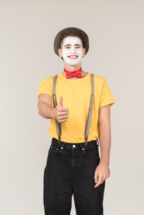 Smiling male clown showing thumb up